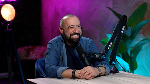 Laughing solo podcaster with green light background recorded at podcast studio Dubai Dubai podcast studio