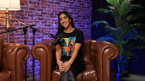 Female guest on brown leather chair, smiling during recording at Dubai podcast studio podcast studio Dubai
