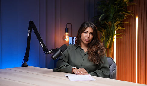 Calm female host with green shirt on elegant studio background Dubai podcast studio shoot podcast studio Dubai