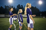 Girls Standing on Soccer Field