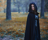 woman standing wearing a cloak