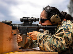 Female solder shooting a rifle