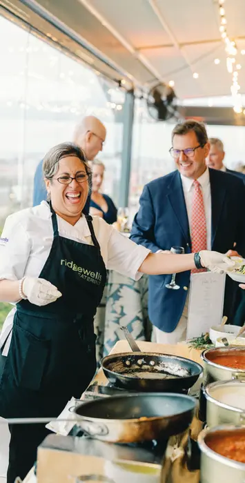 Chef serving guests at pasta station