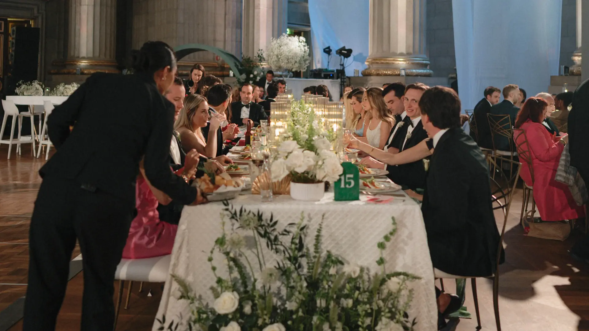 Guests being served dinner at wedding reception.