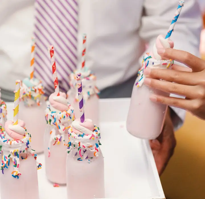 Server offering luxury milkshakes in mason jars