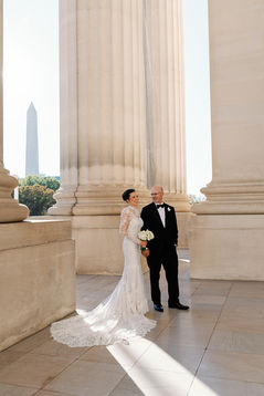 Wedding Couple poses for portraits on the portico overlooking the National Mall at the Andrew W. Mellon Auditorium in Washington DC