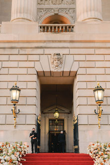 Florals and red carpet line the steps leading up to the entrance of the Andrew W. Mellon Auditorium on Constitution Ave.