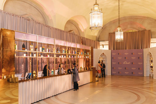 Long velvet-accented check-in desk in the foyer of the Andrew W. Mellon Auditorium for the 2025 Diwali Celebration.
