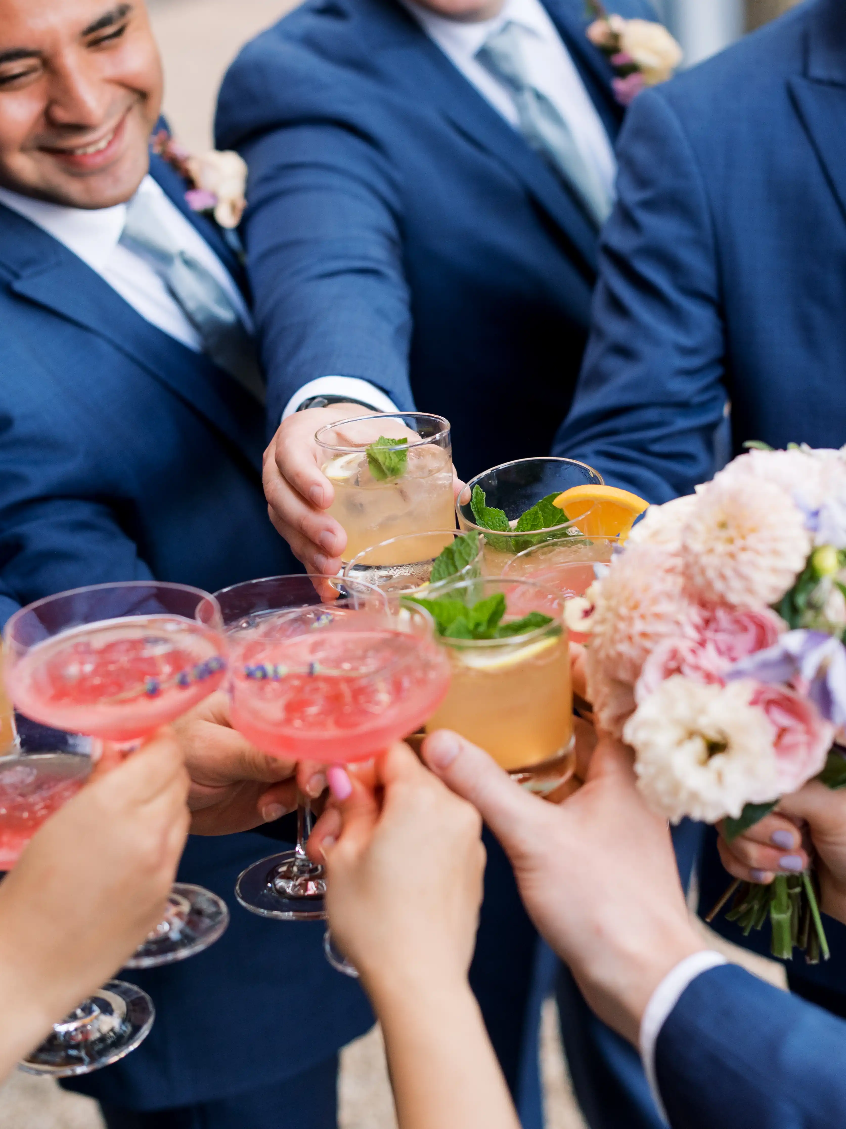 group of people cheering with brightly colored drinks