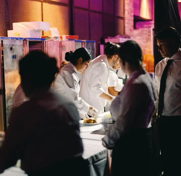 Chefs plating dinners