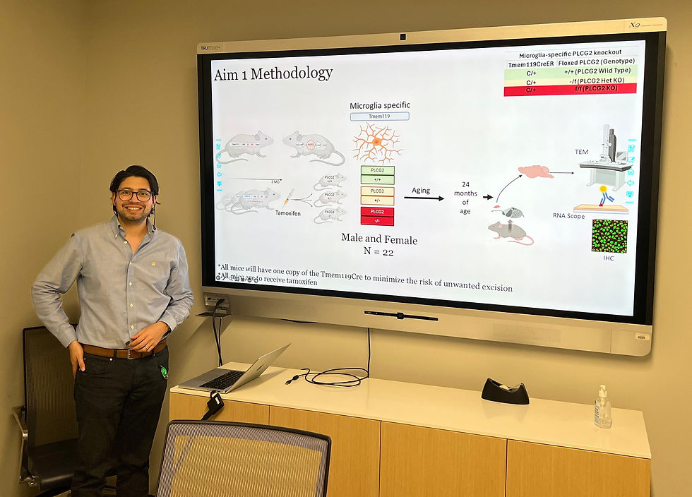Eduardo proudly stands after passing his Qualifying Exam with honors