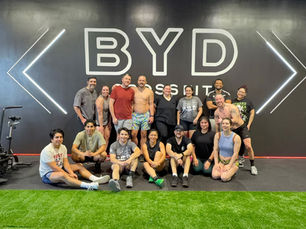 Members participating in a group CrossFit workout at Build Your Dreams CrossFit in Houston, Texas.