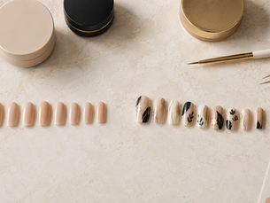 Plain press-on nails transformed into a coordinated custom nail-art set