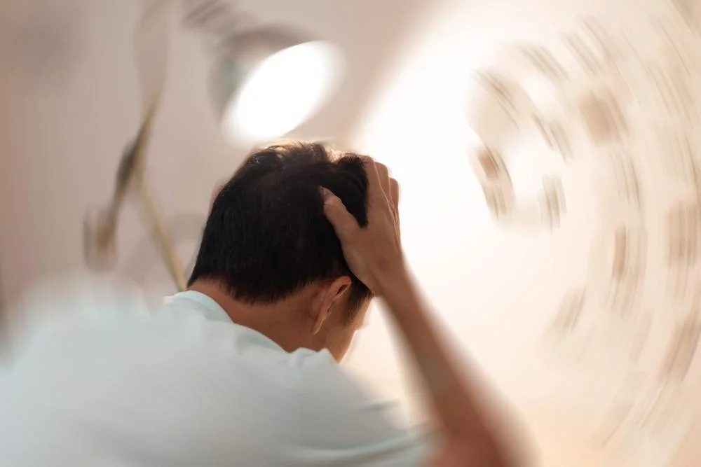 a person feeling dizzy