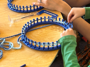 Photo of children making hats on loom