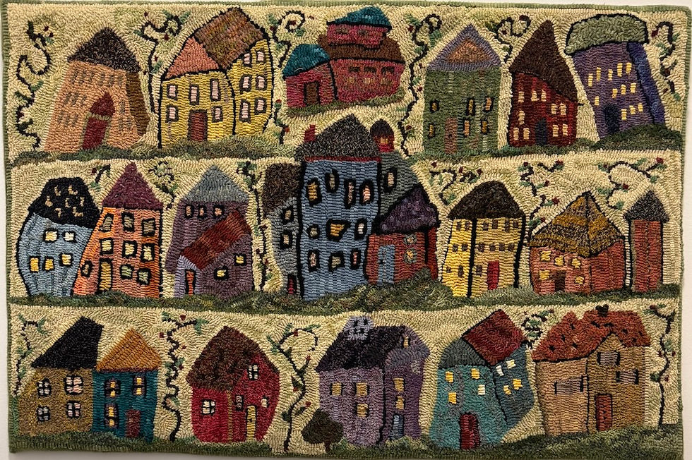 Little Houses, designed by Sharon Smith, and hooked by Andrea. She didn't have a teacher for this one. "The funky fun colors drew me to this rug," Andrea said. This charmer hangs on the main floor of the house. I just love those squiggly trees between the houses, almost as much as the houses themselves!