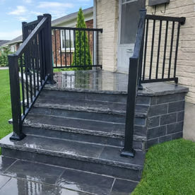 Front porch renovated in Oshawa with Banas stone veneer steps and Peak aluminum railings installed by SMC Masonry