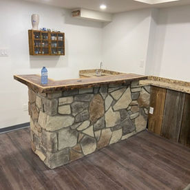 Recreation room bar finished with natural stone veneer installed by SMC Masonry