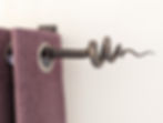 Detail of a handmade wrought iron curtain pole, and curtain