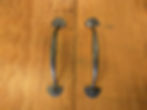 A pair of handmade cupboard door handles