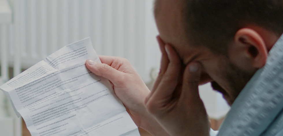adult-with-migraine-reading-paper-with-information-about-medication-against-flu-symptoms-s