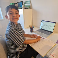 8-11 year old boy looking happy and preparing for online for 11 Plus