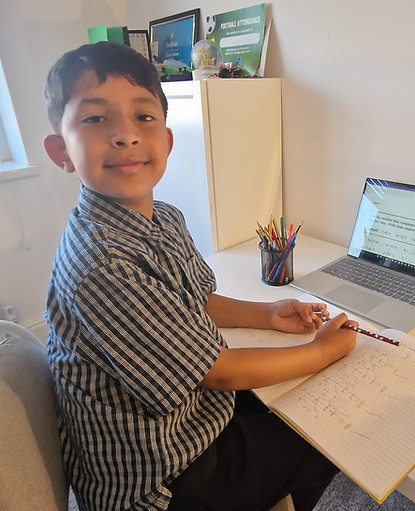 8-11 year old boy looking happy and studying for 11 Plus