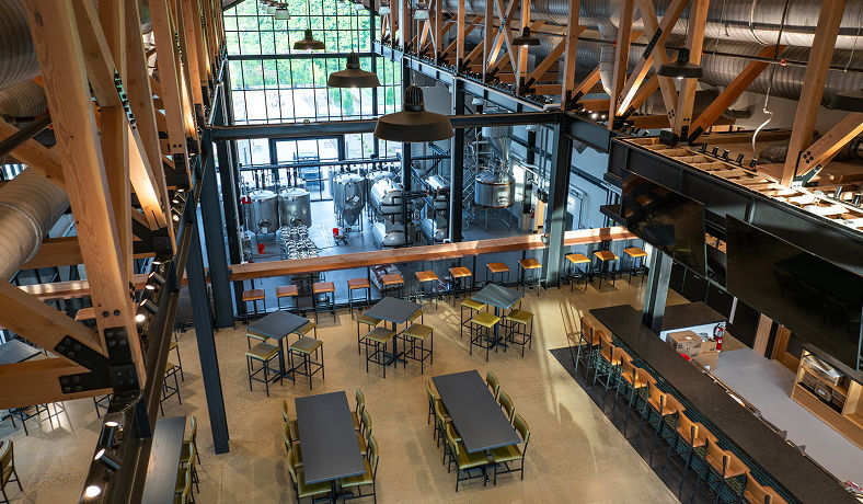 Overhead view of Bottom Creek restaurant, taproom, and craft brewery showcasing the open dining space and brewing equipment