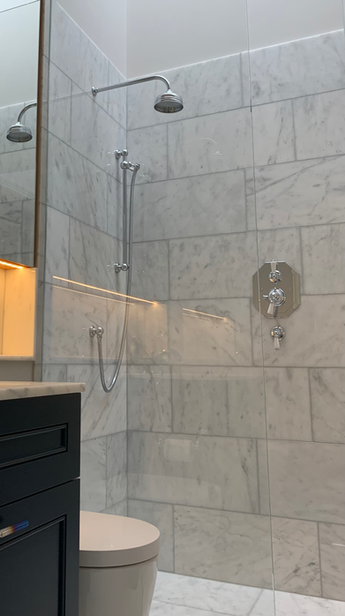 Modern bathroom with marble tile shower, toilet, and vanity, MSQ Design