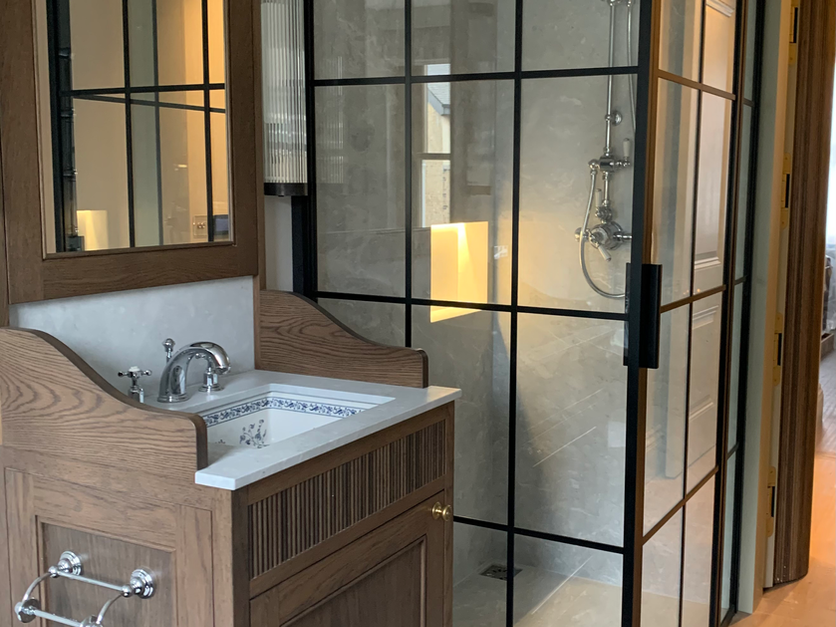 Bathroom with glass shower and wooden vanity, interior design services