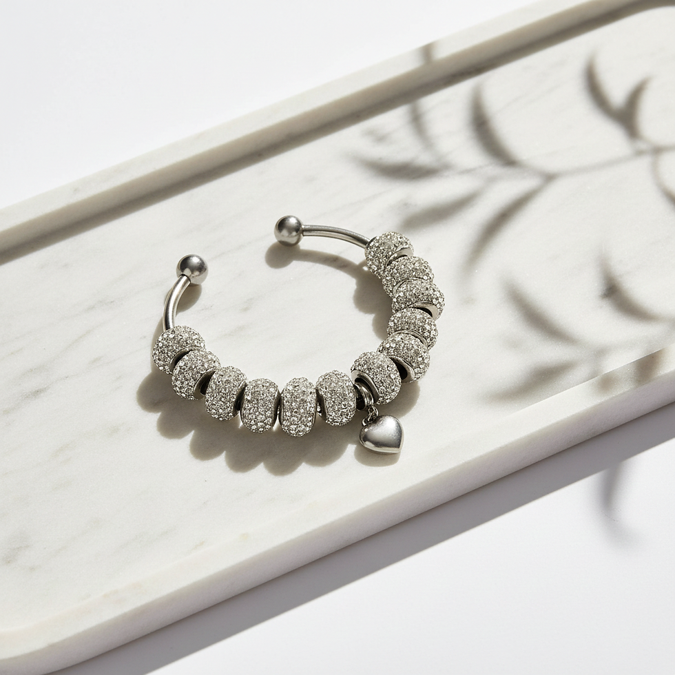 Close-up view of a silver necklace with engraved initials