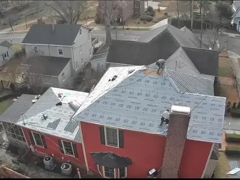 Metal roofing construction on a multi-level home by a top-rated roofing business offering expert roofing services and certified roof installation.