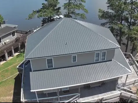Metal roofing construction on a multi-level home by a top-rated roofing business offering expert roofing services and certified roof installation.