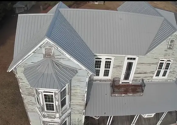 Overhead view of metal roofing installation on an older downtown building by verified and licensed roofers.
