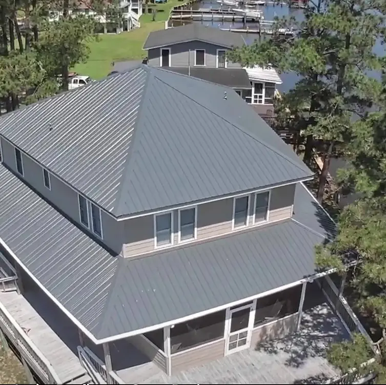 High-angle view of a complete gray roof replacement project in progress.