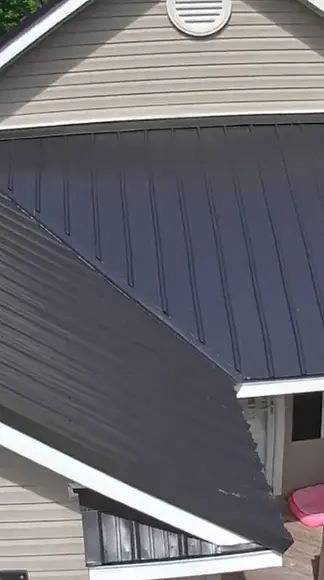 igh-angle view of a complete gray roof replacement project in progress.