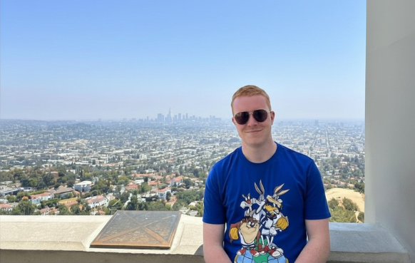 The business owner, Sam Carruthers, stood in front of the Los Angeles skyline