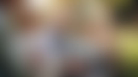 happy family sitting together in grass at the park