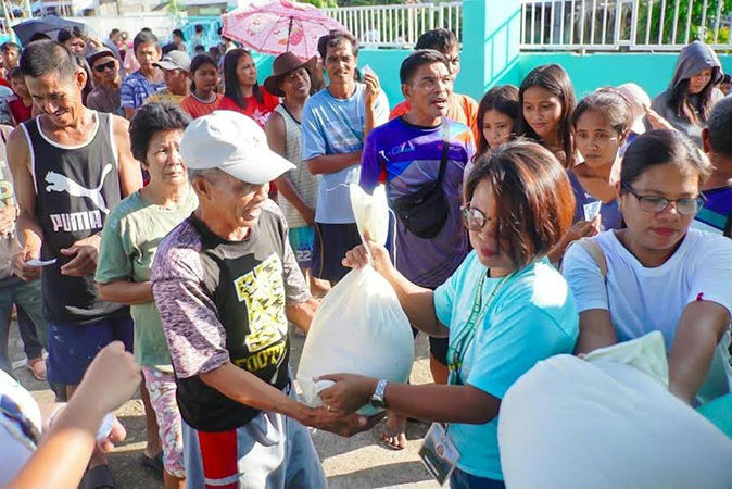 Residents receive their share of rice aid during the distribution of LGSF-funded rice in Pandan, Catanduanes. (Image from the Municipality of Pandan)