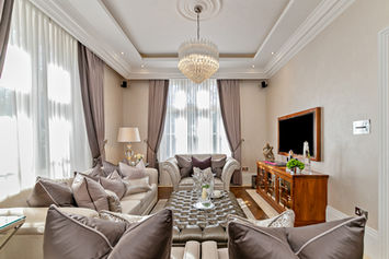 Elegant living room with comfortable sofas and crystal chandelier