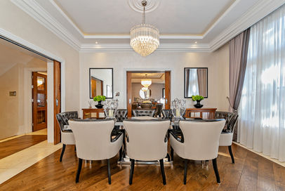 Elegant dining room with a long table and chandelier