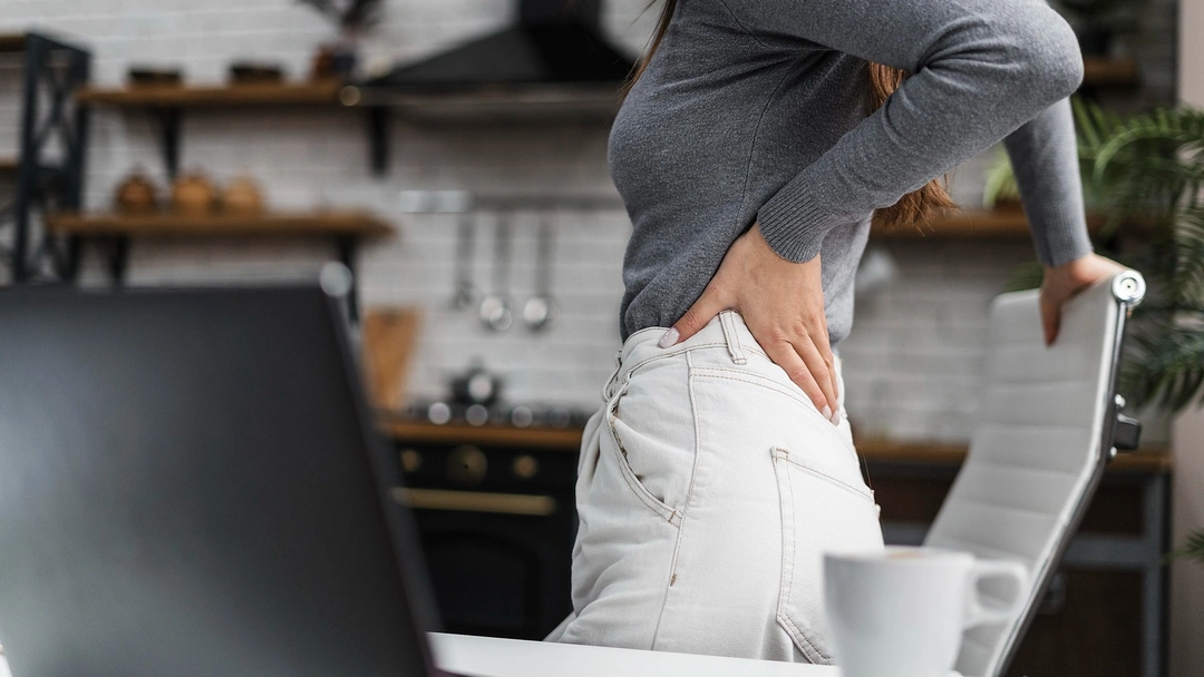 side-view-woman-having-backache-while-working-from-home.webp
