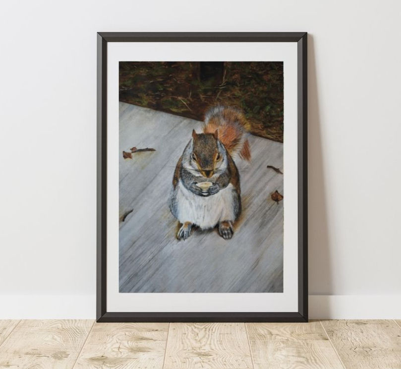 Thumbnail: Watercolor squirrel art in a black frame situated at the base of a wall in a hallway with hardwood floors.