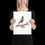 Thumbnail: Young girl holding a framed robin art print gently in her hands standing in a warmly lit room.