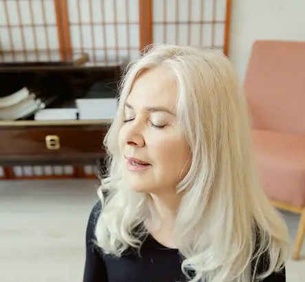 A woman doing a practice to relax her nervous system for better sleep.