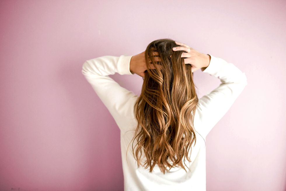 herbs for hair growth and thickness: back of woman showing her luxurious hair