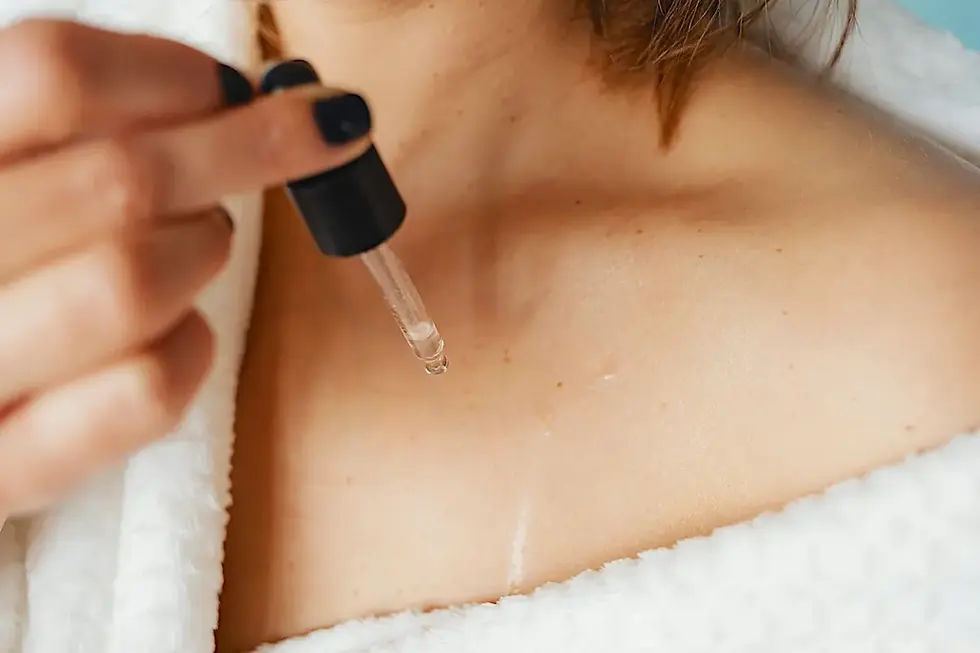 Woman performing abhyanga, self-massage with warm oil, as a winter routine for women 40+.