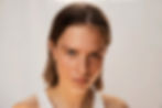 Pitta dosha symptoms: angry woman with pitta dosha characteristics of light, fine hair and sharp, penetrating features looking at the camera