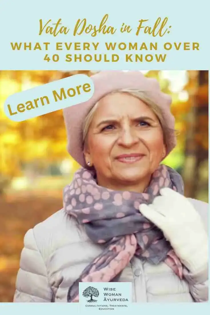 Woman in fall attire with a pink beret and scarf smiles in a leafy autumn background. Text: "Vata Dosha in Fall: What Every Woman Over 40 Should Know" and "Learn More."