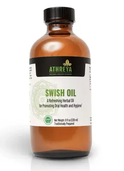 Bottle of Swish Oil by Athreya Herbs, an oil pulling blend for natural oral care.